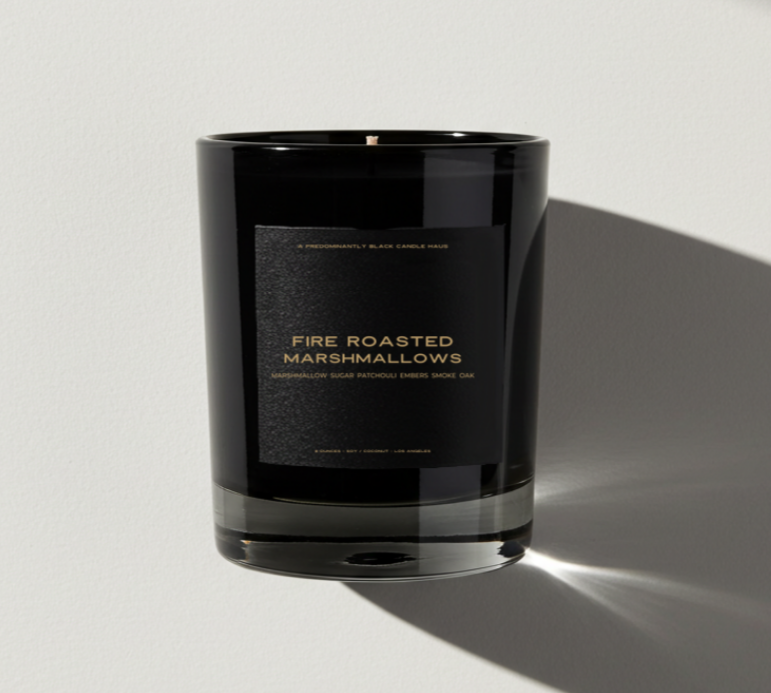 Black candle with 'Fire Roasted Marshmallows' label on a light gray background