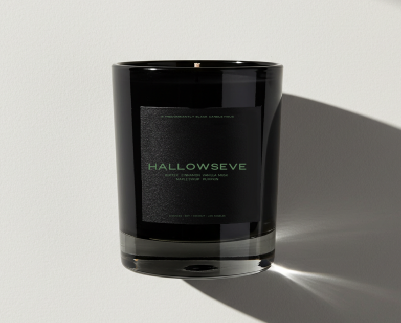 Black candle jar with 'HALLOWSEVE' branding on a light gray background