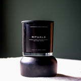 A Predominantly Black branded candle displayed against a predominantly black background, evoking an atmosphere of calm and serenity.