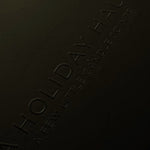 Dark surface with 'Holiday Haus' branding embossed on it