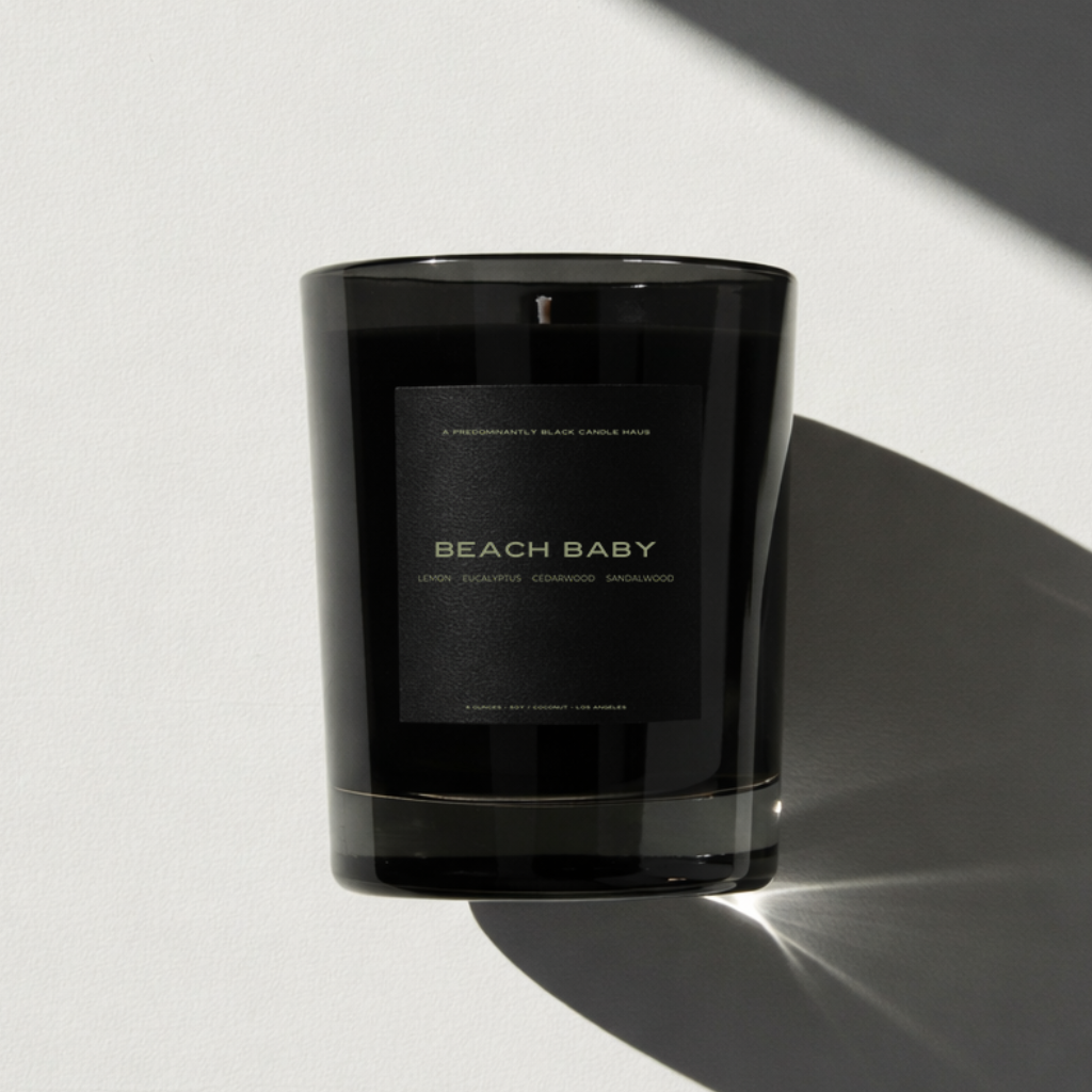 Beach Baby scented candle by Predominantly Black Candle Haus 
in a 10 oz glossy black glass vessel — lemon, eucalyptus, 
peppermint, cedarwood, sandalwood and musk. Coastal, breezy, 
coastal home fragrance. Non-toxic soy-coconut blend.