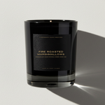 Black candle with 'Fire Roasted Marshmallows' label on a light gray background