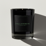 Black candle jar with 'HALLOWSEVE' branding on a light gray background