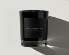 Black candle jar with 'HALLOWSEVE' branding on a light gray background