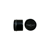 Predominantly Black cylindrical MADNESS candle container with lid, featuring minimalist label design.
