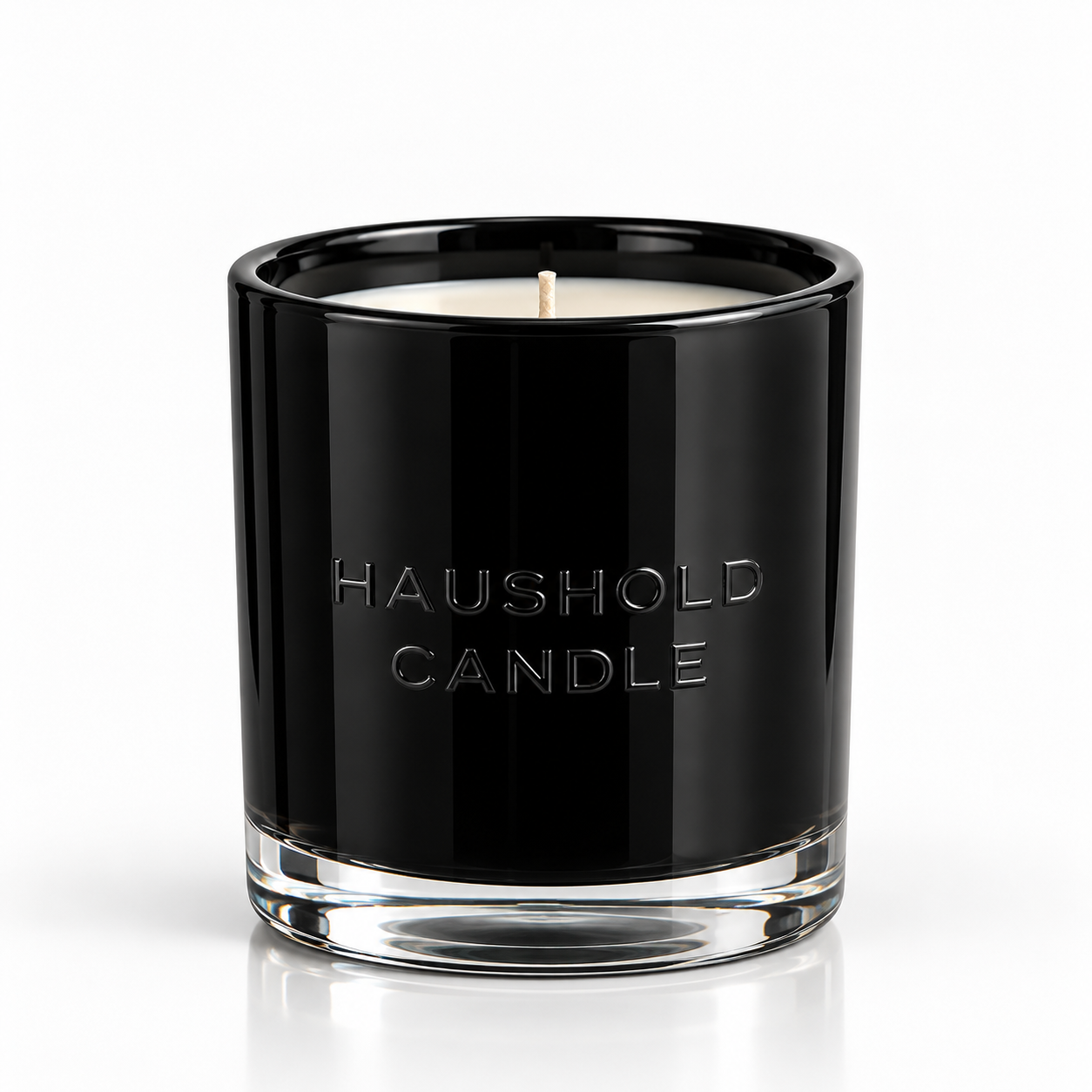 A HAUSHOLD soy-coconut scented candle in black glass; black cardamom and cream fragrance — Predominantly Black