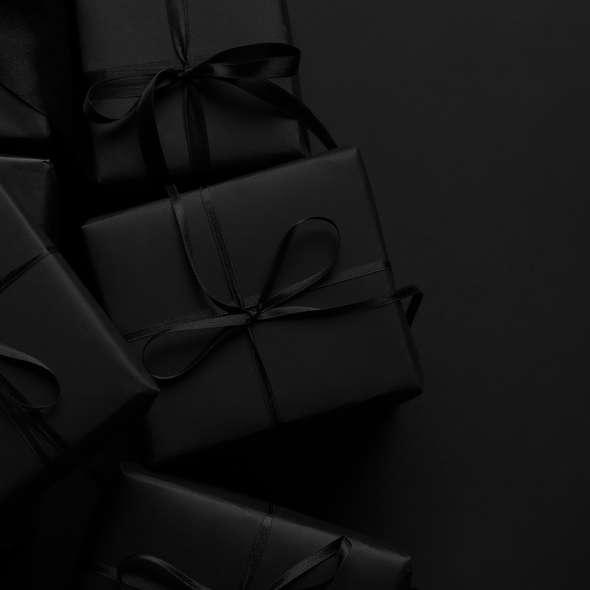 HAUS Gift Wrapping: black gift boxes tied with black ribbon — Predominantly Black