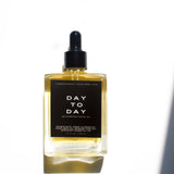 Skin Maintenance System: DAY-TO-DAY facial oil bottle in sunlight — Predominantly Black