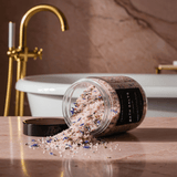 GOODNIGHT bath salts spilling from a jar beside a bath; lavender fragrance — Predominantly Black