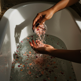 Wild Rose Bath Salts: hand pouring rose bath salts into a tub; rose and jasmine fragrance — Predominantly Black