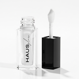 HAUS GLOSS bottle with applicator beside black cap — Predominantly Black