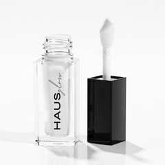 HAUS GLOSS bottle with applicator beside black cap — Predominantly Black