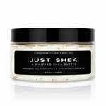 JUST SHEA whipped shea body butter in a clear jar with a black lid — Predominantly Black