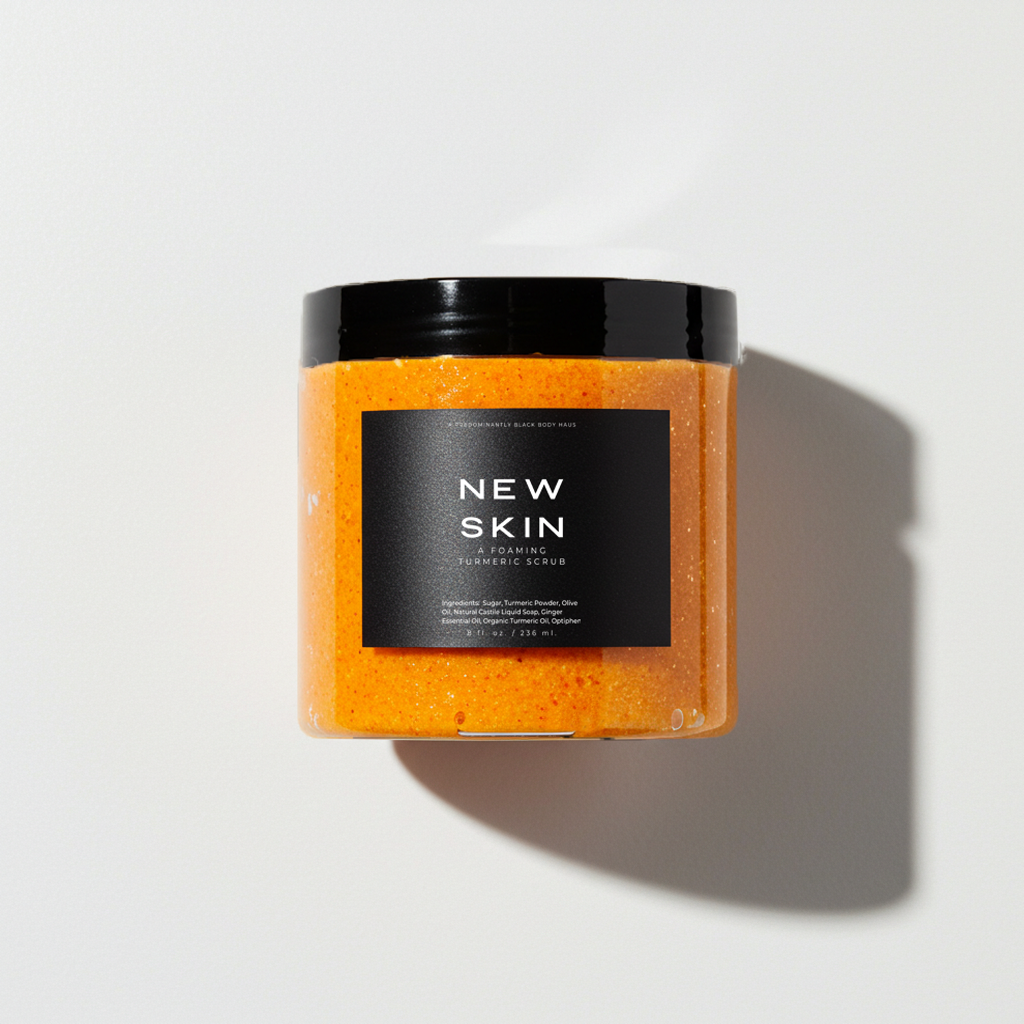 Skin Maintenance System: NEW SKIN foaming turmeric body scrub jar in sunlight — Predominantly Black