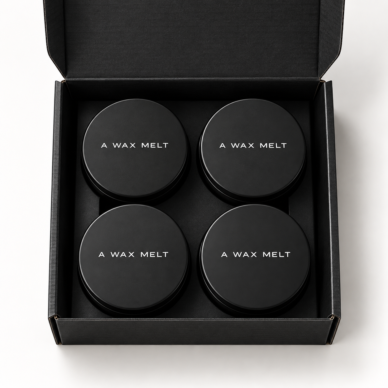 Core Collection Wax Melt Gift Set: open black wax melt gift box showing four visible tins — Predominantly Black
