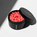 Open OPULENCE scented wax melt tin with red pieces; rose and black oud fragrance — Predominantly Black