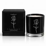OPULENCE illustrated soy-coconut scented candle beside its black box; rose and black oud fragrance — Predominantly Black