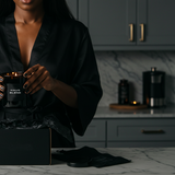 HAUS DISCOVERY soy-coconut scented candle Subscription: person holding a candle in a dark interior — Predominantly Black