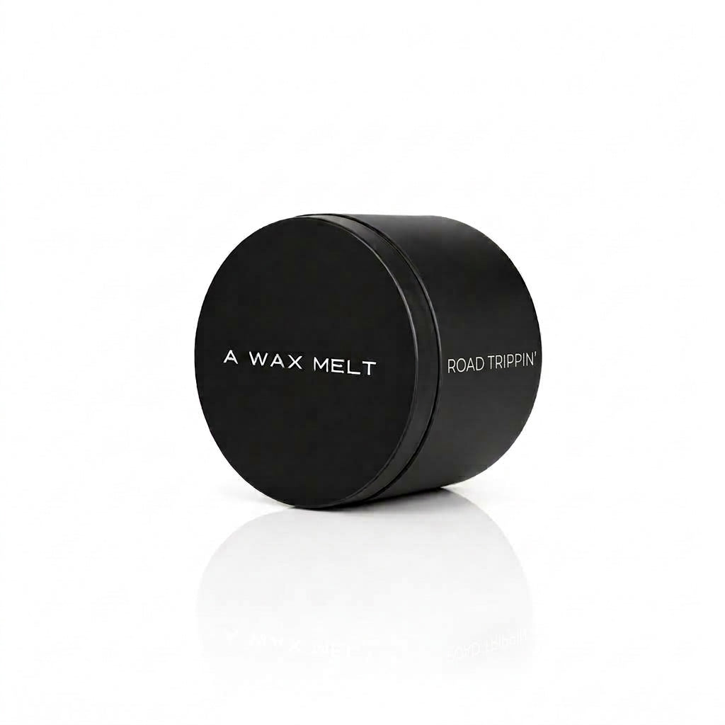 ROAD TRIPPIN' wax melt in a closed black tin; black pepper and sandalwood fragrance — Predominantly Black