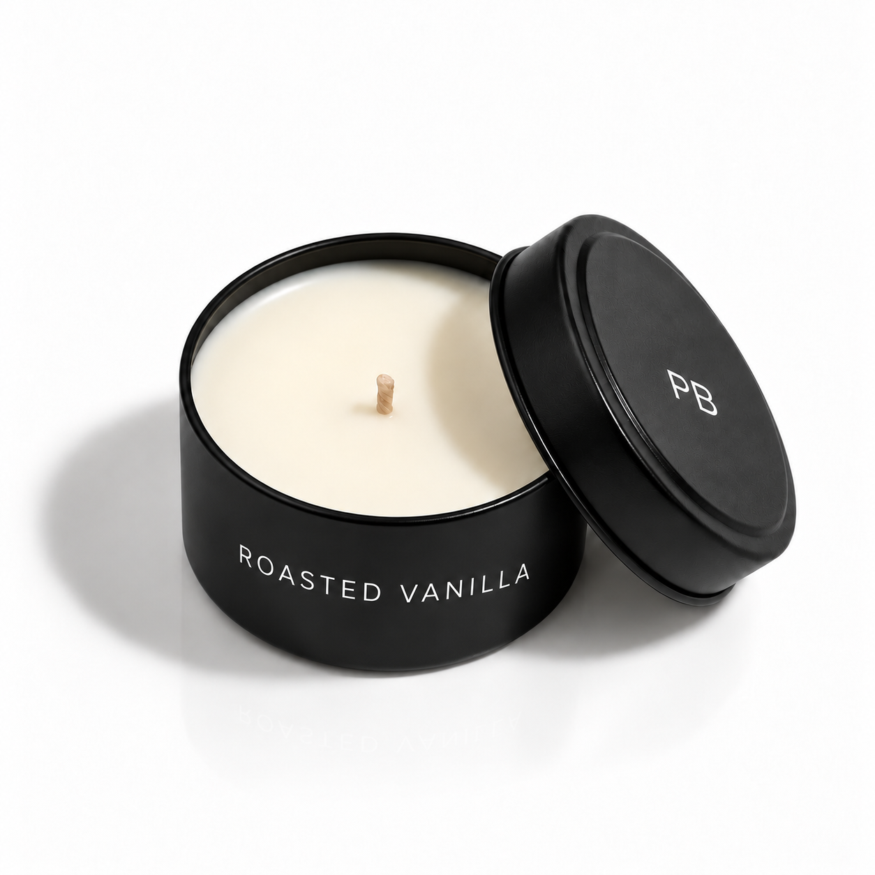 ROASTED VANILLA 2 oz Tiny Tin mini scented candle with lid removed; smoky vanilla and sandalwood fragrance — Predominantly Black