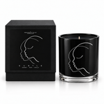 SUBTLE black illustrated soy-coconut scented candle beside its matching box; coconut and vanilla fragrance — Predominantly Black