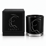 SUBTLE black illustrated soy-coconut scented candle beside its matching box; coconut and vanilla fragrance — Predominantly Black