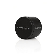 SUBTLE wax melt in a closed black tin; coconut and vanilla fragrance — Predominantly Black