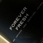 Close-up of FOREVER FRESH candle label; lemon and clean linen fragrance — Predominantly Black