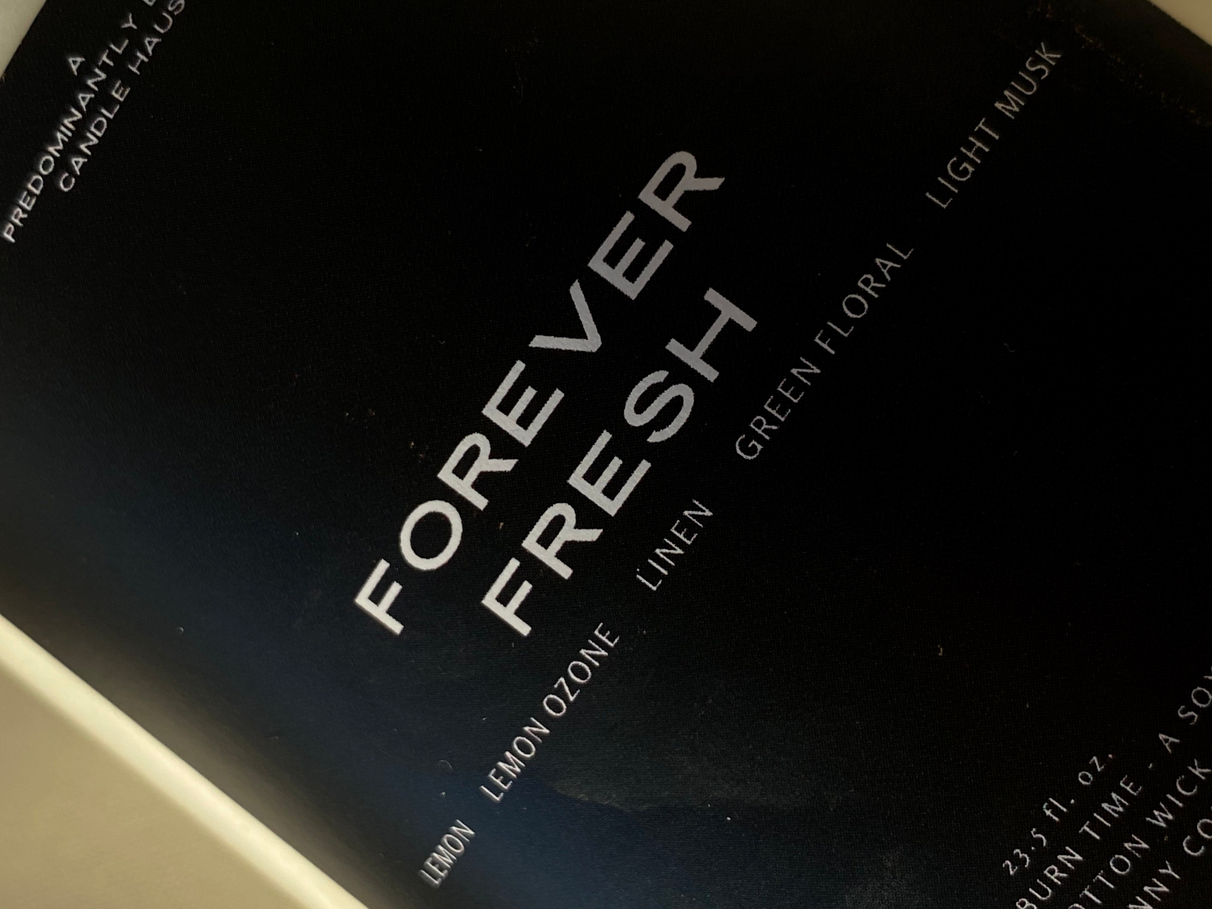 Close-up of FOREVER FRESH candle label; lemon and clean linen fragrance — Predominantly Black