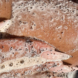 WOKE Coffee Scrub: coffee scrub lather on a hand — Predominantly Black